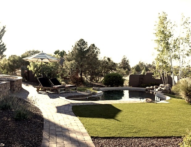 Large southwest backyard brick and custom-shaped pool fountain photo