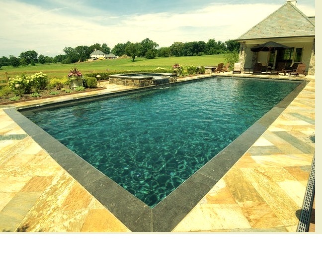 Hot tub - large traditional backyard stone and rectangular lap hot tub idea